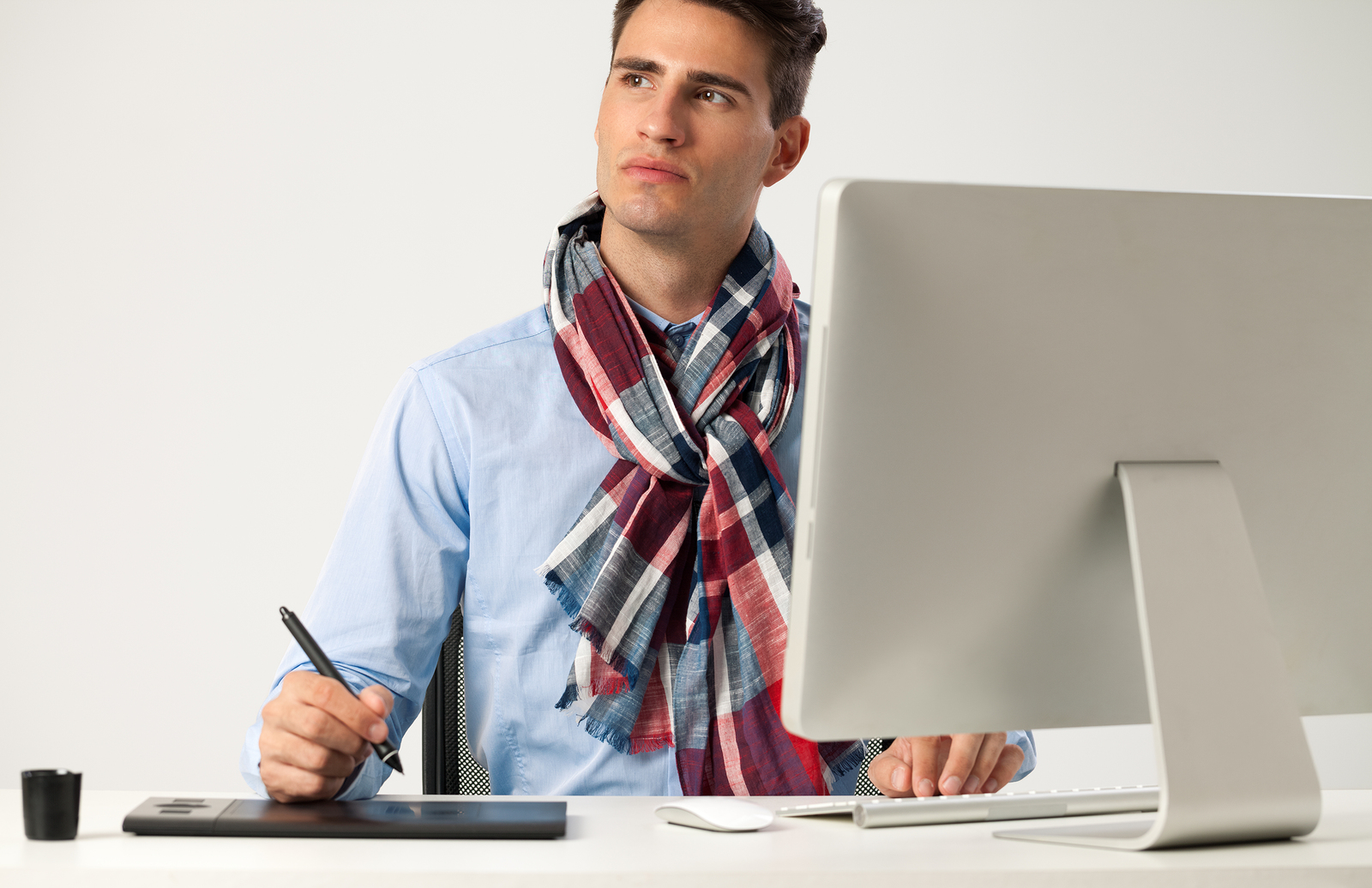Graphic designer using graphics tablet to do his work at desk Media Release Headline Brainstorm